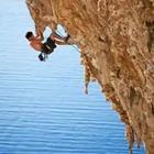 A person hanging on the side of a cliff